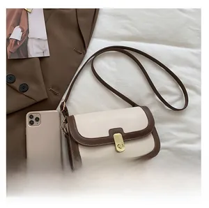 Detail of vintage PU leather small crossbody bag with metal gold square lock closure