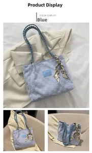 Detail of light blue woven tote bag featuring braided handles and vintage silk scarf detail