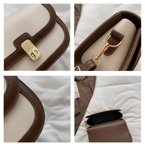 Detail of vintage bicolor handbag with gold striped lock and fine stitching texture