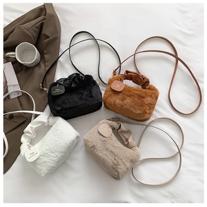 Flat lay of colorful plush faux fur handbags with pleated leather handles and straps