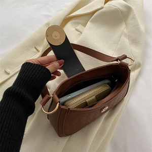 Brown quilted leather shoulder bag featuring a metal magnetic clasp and spacious interior