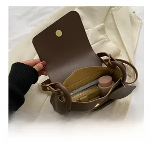 Detail view of the brown shoulder bag interior showing daily storage capacity