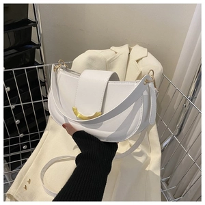 Détail du sac de selle hobo blanc avec une boucle métallique dorée en forme de croissant