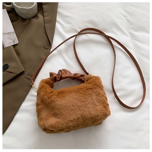 Close-up of brown plush crossbody bag with PU leather handle and soft faux fur texture