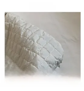 Close-up of the elegant quilted pattern and fine stitching on the white large tote bag