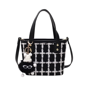 Fashionable black and white tweed bucket bag with leather handle and plush doll charm