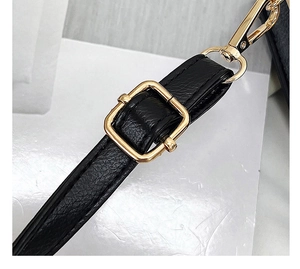 Detail of black lychee grain faux leather strap with adjustable gold buckle and lobster clasp
