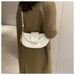 Chic white crescent saddle bag with glossy finish and gold metal hardware