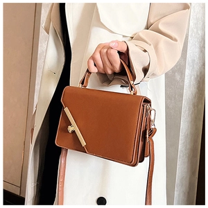 Brown rectangular handbag featuring heart-shaped metal buckle and matte leather texture