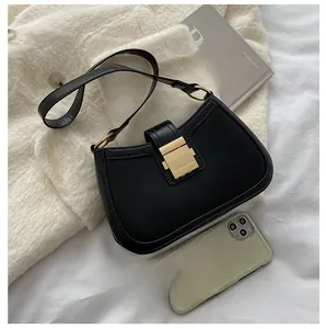 Detailed comparison of the black crescent shoulder bag size with a smartphone