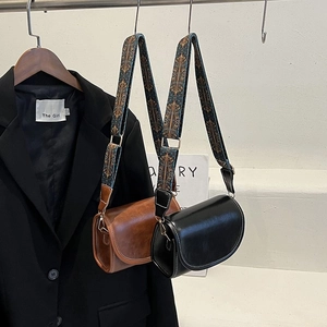Retro saddle crossbody bag in black and brown PU leather with jacquard strap