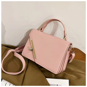 Macro detail of pink faux leather texture and elegant gold twist lock on handbag