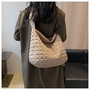 Detailed back view of a large beige quilted hobo bag with a metallic nylon finish
