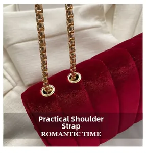 Detail of burgundy velvet handbag showing gold metal eyelets and durable chain strap