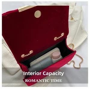 Internal capacity of red velvet crossbody bag showing storage for phone and makeup
