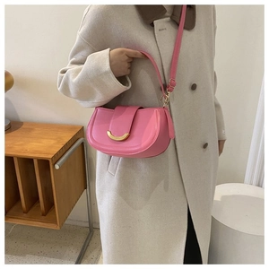 Pink matte leather saddle bag with gold crescent moon buckle and adjustable shoulder strap