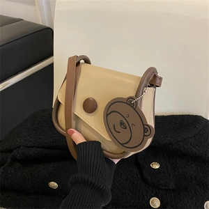 Chic beige and brown crossbody bag with round decorative buckle and bear charm