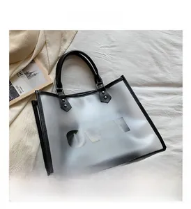 Detail of transparent black tote bag with OWU lettering on a white fabric background