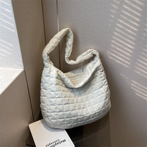 Large off-white quilted puffer shoulder bag with a soft padded finish and wide strap