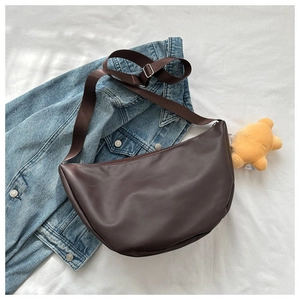 Detail of dark brown matte PU leather half-moon bag with adjustable wide shoulder strap