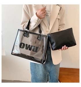 Detailed shot of transparent PVC tote bag with OWU lettering and black inner pouch