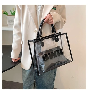 Detail of transparent PVC tote bag with black inner pouch featuring OWU letter print