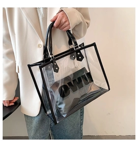 Detail of transparent PVC tote bag with black leather trim and internal pouch