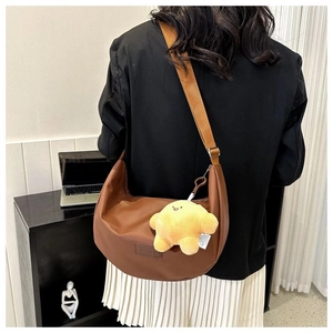 Brown half-moon crossbody bag with fashion embossing and cute yellow duck charm detail