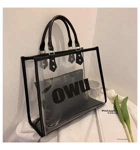 Detail of transparent PVC tote bag with black trim and OWU lettered inner pouch