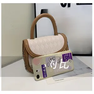 Detailed size comparison of a mini quilted saddle bag with a phone for reference