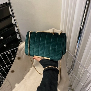 Dark green velvet chain bag with vertical quilting and golden metal hardware detail