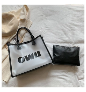 Macro shot of large transparent PVC tote bag featuring black OWU print and inner pouch