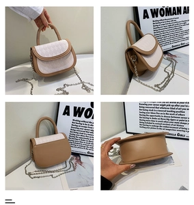 Detail view of contrast color saddle bag with rhombus texture and metal chain strap