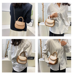 Detail view of quilted leather mini bags in beige and white with metal chain straps