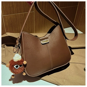 Brown PU leather crescent bucket bag with FASHION logo and plush monster charm