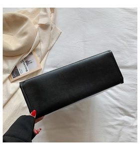 Detailed base view of black tote bag showing precise stitching and leather texture