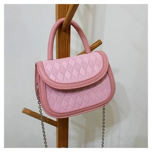 Detail view of pink quilted handbag featuring a curved flap and silver chain strap