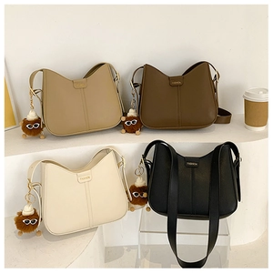 Detailed display of four multi-colored hobo bucket bags with chic sunglasses plush charms