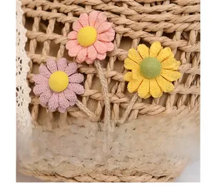 Detailed macro view of woven straw texture with colorful fabric daisies and ladybug decor