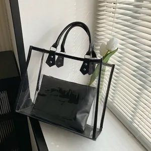 Minimalist transparent PVC tote bag with black inner pouch and sleek round handles