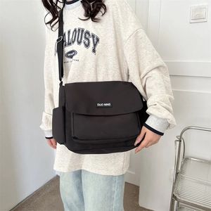 Minimalist black canvas messenger bag with large capacity for casual daily wear