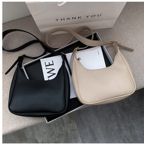 Minimalist hobo bags in black and beige displayed with adjustable shoulder straps
