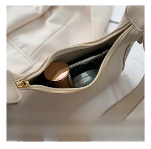 Macro view of beige crescent hobo bag interior with room for cosmetics and daily items