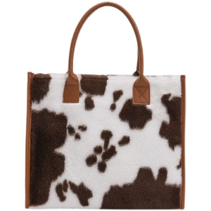 Stylish brown cow print faux fur tote bag with premium leather handles for women