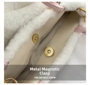 Detail view of the magnetic metal buckle closure on the white plush cherry handbag