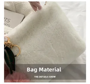 Macro detail of white faux fur material on plush handbag with pink charm and gold hook
