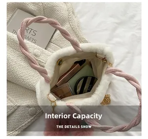 Detail view of the white plush bucket bag showing its magnetic buckle and internal capacity
