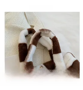 Detail of checkered plush laptop bag featuring padded handle and magnetic metal clasp