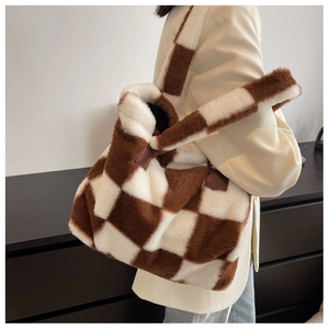 Detail of plush checkered tote bag featuring soft brown and white faux fur texture