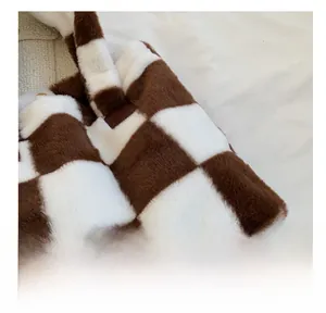 Close-up of the soft brown and white checkered plush fabric and texture on a tote bag